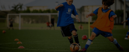 Two kids playing football
